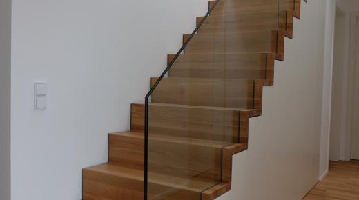 Holztreppe mit Einbauschrank und Glasgeländer 